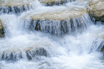 Fototapeta premium The mesmerizing flow of a cascading waterfall, embodying the rhythm of nature's serene pulse