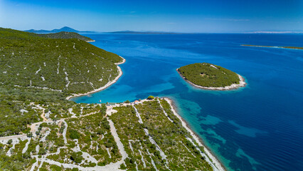 Aerial view of the rocky coast and crystal clear waters on a clear day, Losinj Island, Croatia