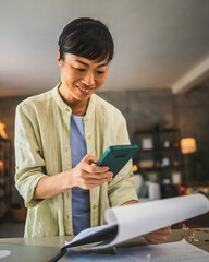 japanese woman work from home and scan document with mobile phone