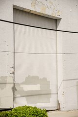 Photo of an industrial wall with metal roll up garage bay door