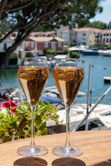 Summer party, French brut rose champagne sparkling wine in flute glasses in yacht harbour of Port Grimaud near Saint-Tropez, French Riviera vacation, Var, France