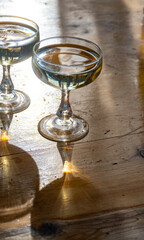 Sparkling wine, cava or champagne in two coupe glasses on wooden table, French Riviera is summer, France