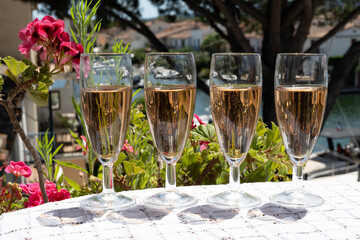 Summer party, French brut rose champagne sparkling wine in flute glasses in yacht harbour of Port Grimaud near Saint-Tropez, French Riviera vacation, Var, France