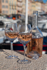 Glasses of cold rose Cote de Provence wine in old fisherman boats and yacht harbour in Saint-Tropez, summer vacation on French Riviera in Provence, France