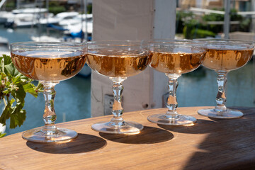 Summer party, French brut rose champagne sparkling wine in coupe glasses in yacht harbour of Port Grimaud near Saint-Tropez, French Riviera vacation, Var, France