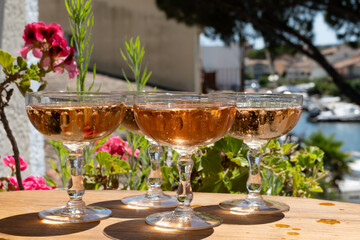 Summer party, French brut rose champagne sparkling wine in coupe glasses in yacht harbour of Port Grimaud near Saint-Tropez, French Riviera vacation, Var, France