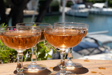 Summer party, French brut rose champagne sparkling wine in coupe glasses in yacht harbour of Port Grimaud near Saint-Tropez, French Riviera vacation, Var, France