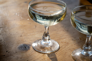 Sparkling wine, cava or champagne in two coupe glasses on wooden table, French Riviera is summer, France