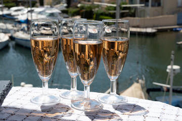 Summer party, French brut rose champagne sparkling wine in flute glasses in yacht harbour of Port Grimaud near Saint-Tropez, French Riviera vacation, Var, France