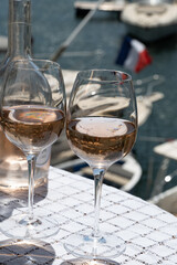 Glasses of cold rose gris Cote de Provence wine in yacht harbour of Port Grimaud, summer vacation on French Riviera in Provence, France