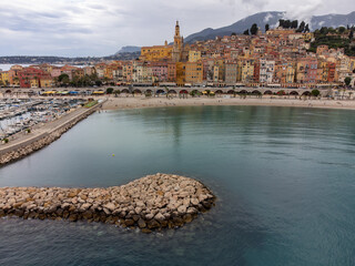 Fototapeta premium Aerial view on French Riviera, colorful Menton old city and marina on Mediterranean Sea near French-Italian border, travel destination, panoramic view from above