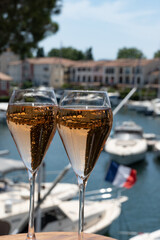 Summer party, French brut rose champagne sparkling wine in flute glasses in yacht harbour of Port Grimaud near Saint-Tropez, French Riviera vacation, Var, France