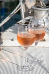 Party with rose wine on yacht boat anchored in port la Rague, Gulf of La Napoule, in Provence, two glasses of cold rose wine, French Riviera near Cannes, south of France