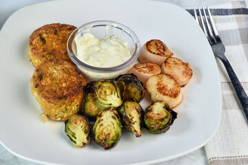  crab cakes with scallops and brussel sprouts