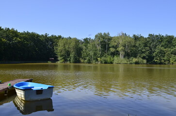 small boat standing near a wooden pier boat pier river