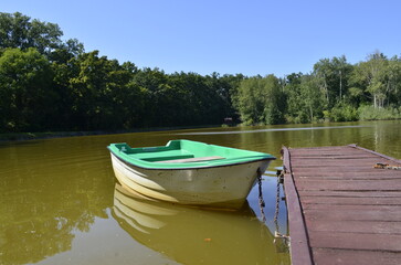 small boat standing near a wooden pier