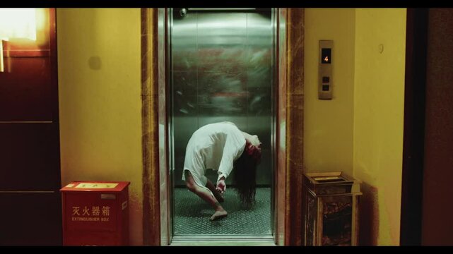 Elevator door opens and a woman is being possessed