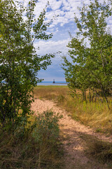 A Breakwater Lighthouse with A Sandy Path To A Sandy Beach