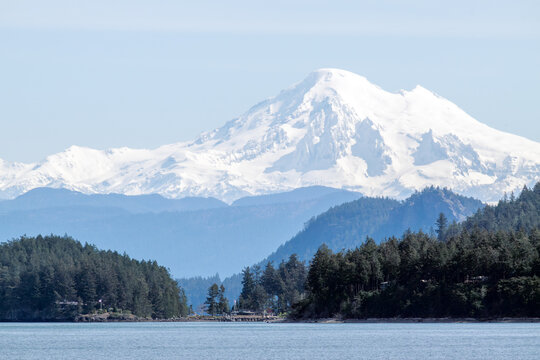 Panoramic view of Puget Sound and the snow-capped North Cascades with Mount Baker seen from a ferry.