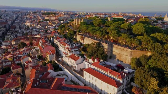Revealing shot of Lisbon downtown and Saint Jorge Castle at the golden hour