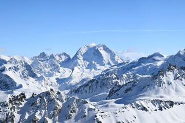 Snowcapped Alpine mountain peaks in the Three Valleys, France. Breathtaking view from popular Courchevel ski resort located in French Tarentaise Valley.