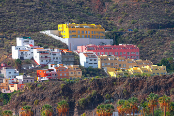 Colorful houses on the island of La Palma, Canary Islands, Spain. Mountain with a row of colorful...