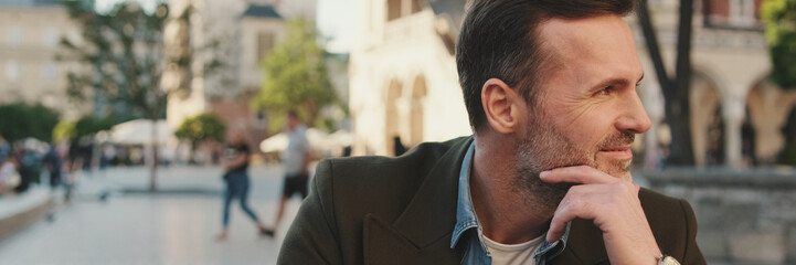 Man sits on the square of the old city