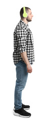 Man in casual clothes with headphones on white background