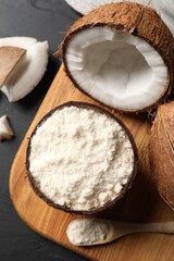 Organic coconut flour and fresh fruits on black table, flat lay