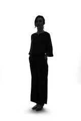 Full-body silhouette of a Caucasian female business person standing in front of a white background