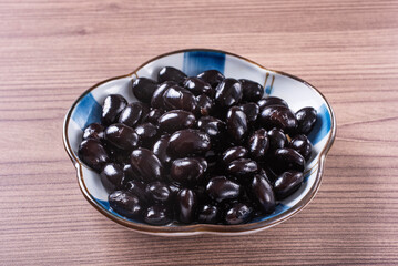 Sweet simmered black beans in a plate   