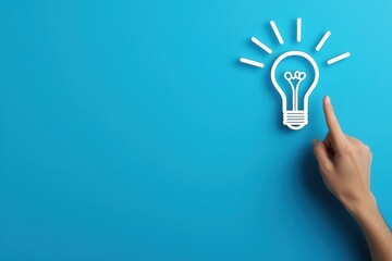 A hand points towards a glowing light bulb icon on a bright blue background, symbolizing creativity, ideas, and innovation.