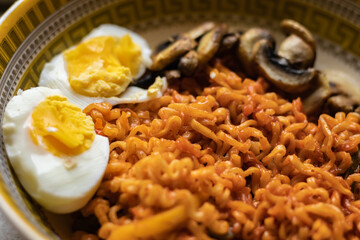 Ramen noodles with boiled egg and mushroom served in traditional bowl. 
