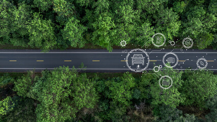 Aerial view car drive in green tree forest road winding road through the forest, Car drive on asphalt road between green tree forest, Electric vehicle EV car drive on asphalt road green tree forest.