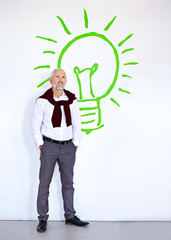 Mature businessman, thinking and wall with lightbulb symbol in modern office with inspiration, solution or vision. Person, ideas and process with sign, icon and emoji at renewable energy company