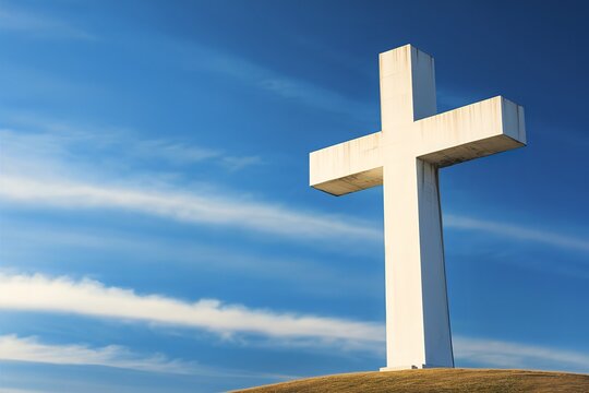 A striking high-quality photo of a massive white cross silhouetted against a deep blue sky