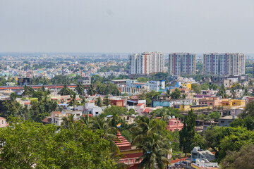 Aerial drone cityscape of bhubaneswar city in odisha. Trees and high rise buildings are seen in the city of temples.