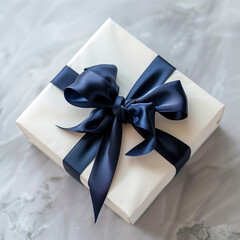 White cube gift box with a silky dark blue ribbon, elegant ribbon bow