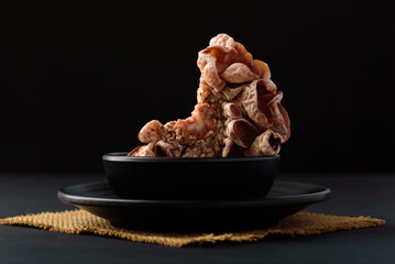 Fresh black jelly mushroom on black background, Local ingredients for vegetarian cooking