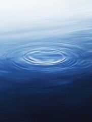 Obraz premium An artistic image capturing a single water ripple expanding under a gradient of blue hues, symbolizing calmness and tranquillity. Generative ai