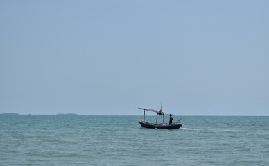 A man standing on a boat. Rayong, Thailand