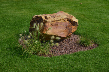decorative stone on a green lawn