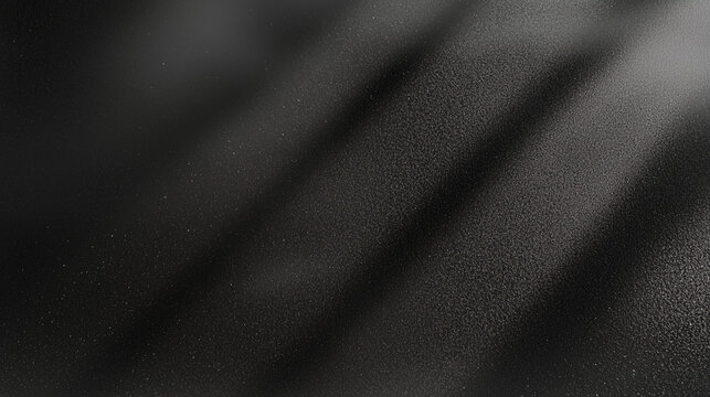 Black matte textured background with floating dust particles illuminated by soft light in the top right corner, creating a deep contrast between black and white. This abstract design emphasizes textur