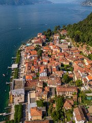 Aerial drone shot of the ancient town Bellagio on Lake Como, surrounded by the mountains of northern Italy