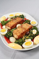 Portuguese cod with eggs, broccoli and peppers on a plate