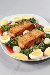 Portuguese cod with eggs, broccoli and peppers on a plate