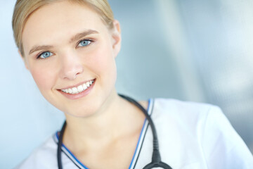 Woman, smile and portrait of nurse at clinic for healthcare, support and career in medicine. Happy, professional and person with stethoscope at hospital for medical service, confidence and wellness