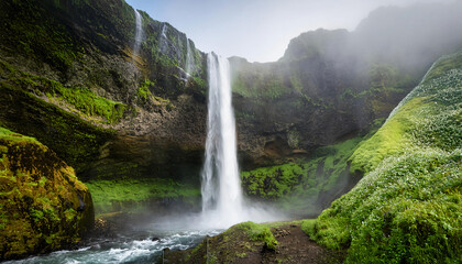 Fototapeta premium A turbulent waterfall cascading down a rocky cliff,