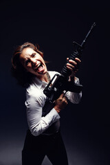 Woman, rifle and professional portrait in studio, angry corporate killer and black background. Female person, mafia boss and gun for fancy gangster business, criminal weapon and danger to security