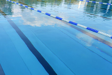 An empty swimming pool with separated swimming lanes.